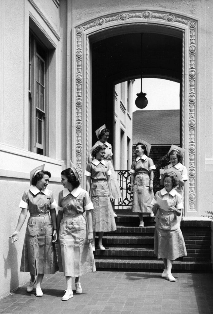 UCSF School of Nursing students in the Nursing Dorm archway, circa 1950s.
