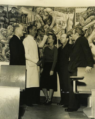 Viewing murals at Toland Hall at UCSF, left to right: F. Stanley Durie, Superintendent of UC Hospital, Dr. William E. Carter, Phyllis Wrightson, Joseph Allen, State Director of WPA Federal Art Project, Bernard Zakehim (ca. 1939)