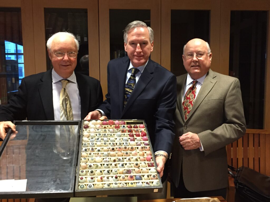 Left to right: ocularists: Phillip Danz of Sacramento and William Danz of San Francisco, and Dr. Robert Sherins, ophthalmologist, UCSF School of Medicine Alumnus Class of 1963 holding the Danz collection of ocular pathology specimens during their visit to the UCSF Archives and special Collection in January, 2015.