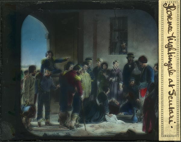 A glass "magic lantern" slide of the painting by Jerry Barrett, “The Mission of Mercy: Florence Nightingale Receiving the Wounded at Scutari” (National Portrait Gallery, London). A photo of a black-and-white engraving has been hand-colored. Read more about this painting on the Country Joe McDonald website.