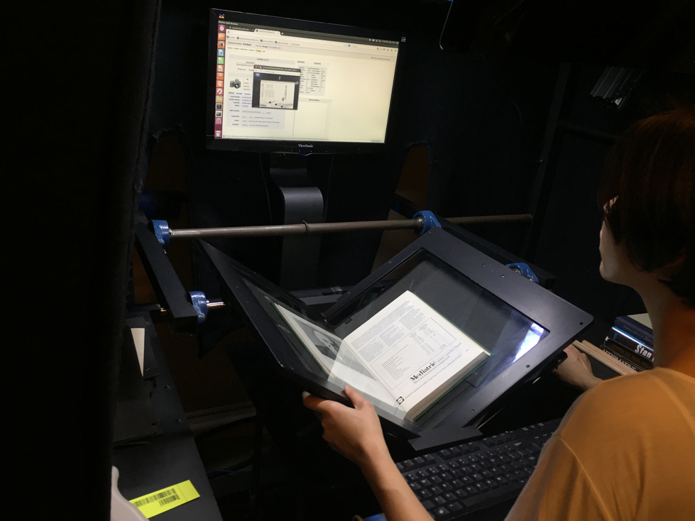 Eliza Zhuang scanning a medical journal from UCSF's collection.