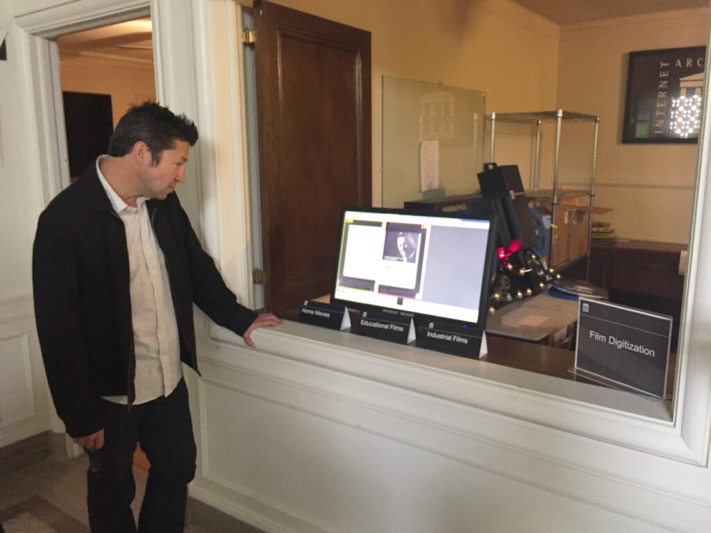 David Uhlich observes the progress of digitized images entering the system.