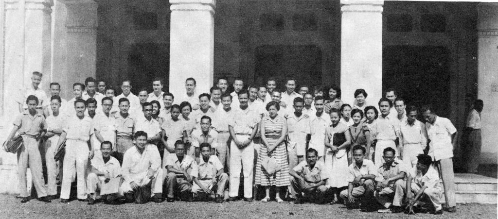 Thomas N. Burbridge with his wife and medical students at the University of Indonesia, circa 1952-1955. Photograph published in the Alumni-Faculty Association Bulletin of the UCSF School of Medicine, Winter 1956. University Publications.