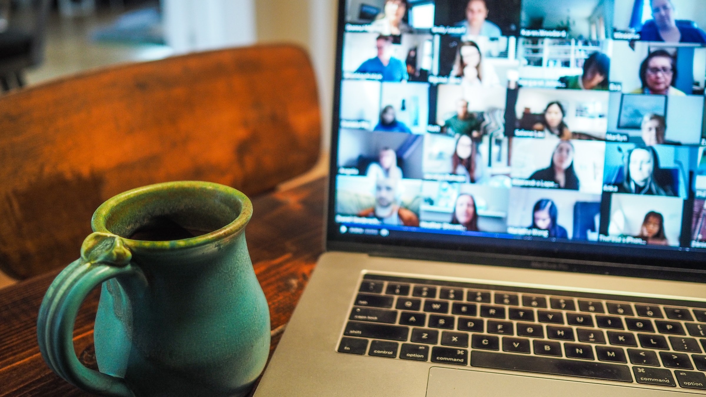 Image of a laptop screen showing a video call with multiple participants