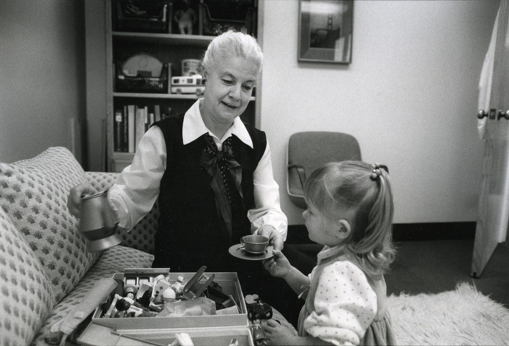 Helen Gofman, MD, playing with girl with tea set and toys